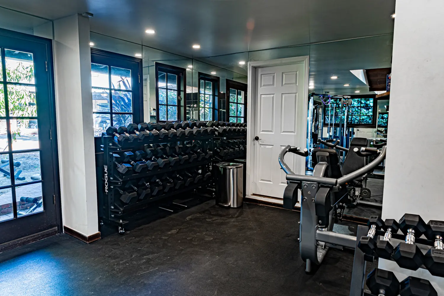 Rack with color-coded plates, adjustable bench, and wall-mounted display